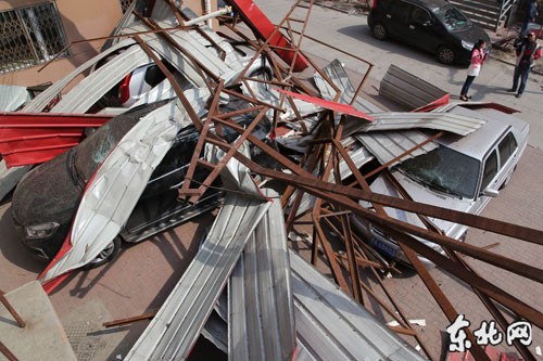 哈尔滨一居民楼楼顶被风掀翻 砸坏9辆车