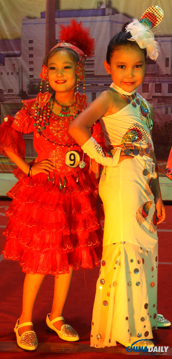 8月20日,小学生身着少数民族多彩服装正在舞台上表演走秀.