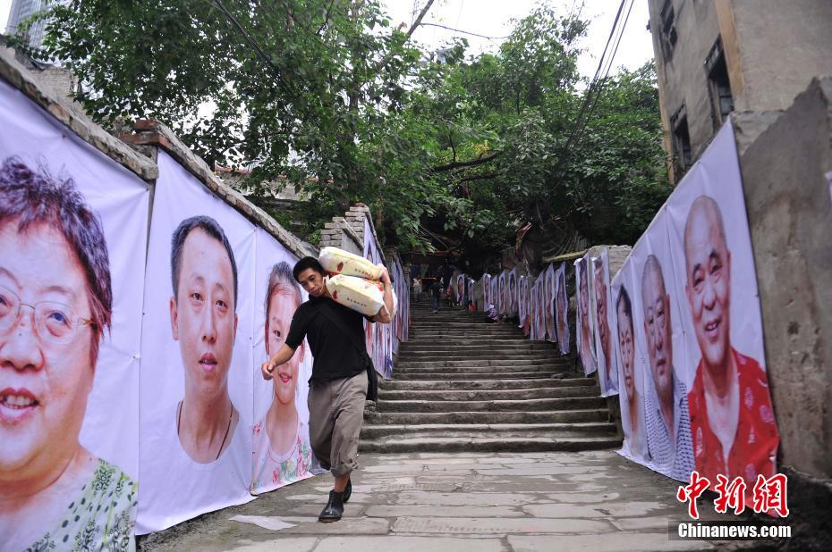 重庆“十八梯”贴满搬迁民众肖像供游客参观