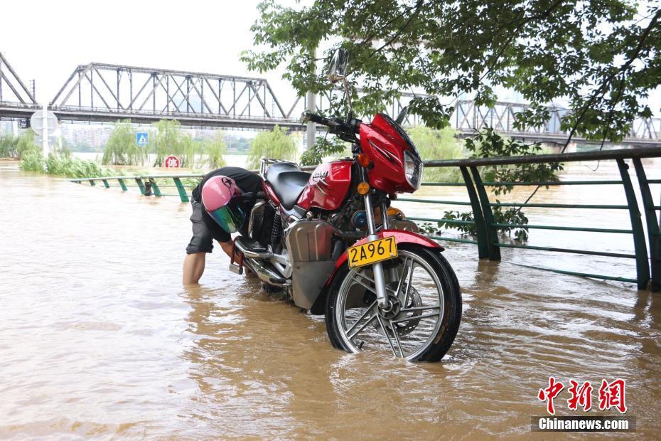 洪峰过境广西柳州 民众水中划船抓鱼