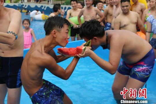 市民泳池里比赛吃西瓜消暑