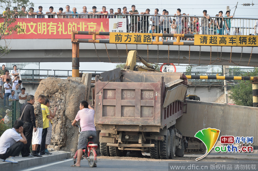 北京一渣土车撞倒限高桥被“卡”动弹不得